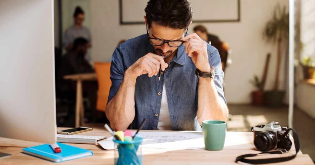 A person deeply focused on work at a clean, organized desk. This visually represents the concept of deep work.